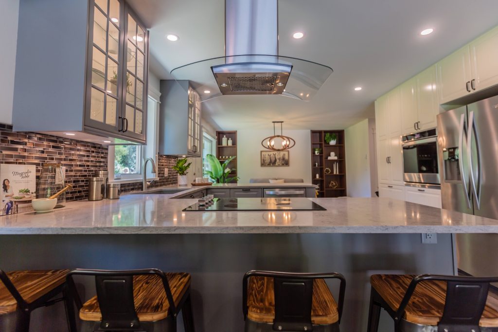Modern kitchen interior featuring a spacious island with a cooktop, stylish cabinetry, and contemporary decor, highlighting renovation ideas for homeowners in the Fraser Valley.