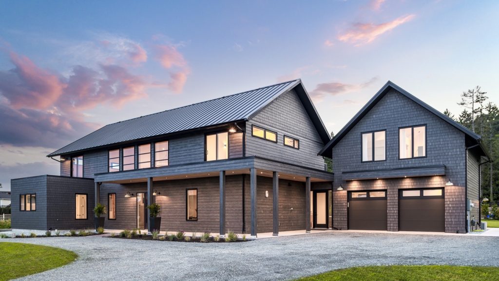 Modern multi-generational home design featuring dark wood exterior, spacious layout, and covered entry, ideal for families in Langley and Abbotsford.